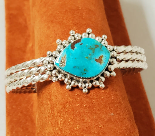 Photo of Bracelet made of 3 piece twist silver band topped with Mineral Park Turquoise surrounded with handmade silver beads.