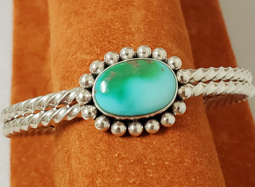 Photo of Bracelet made of 2 piece twist silver band topped with Royston Turquoise surrounded with silver beads