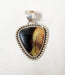 Photo of Simbercite pendant with silver twist wire and handmade beads by Artie Yellowhorse