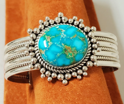 Photo of Bracelet made of 3 pieces twist silver between 4 pieces of plain silver.  Band is topped with Sonoran Gold Turquoise that is surrounded with various size handmade silver beads.