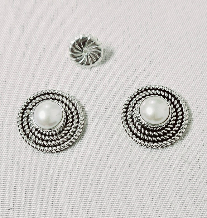 Photo of silver and pearl earrings by Artie Yellowhorse