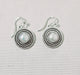 Photo of silver and pearl earrings by Artie Yellowhorse
