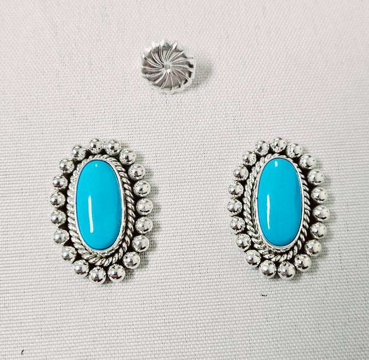 Photo of silver and turquoise earrings by Artie Yellowhorse