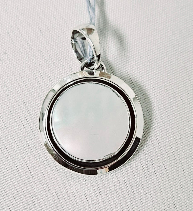 Photo of silver and mother of pearl pendant by Artie Yellowhorse