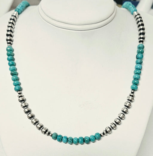 A beaded necklace turquoise-blue round beads alternating with silver 